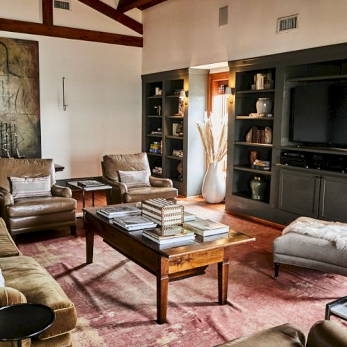 A cozy living room with mid-century furniture, warm lighting, plants, and a small coffee table arranged for a comfortable, stylish setup. ending the sentence.